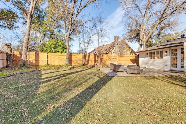 view of yard with outdoor lounge area, a patio area, and french doors