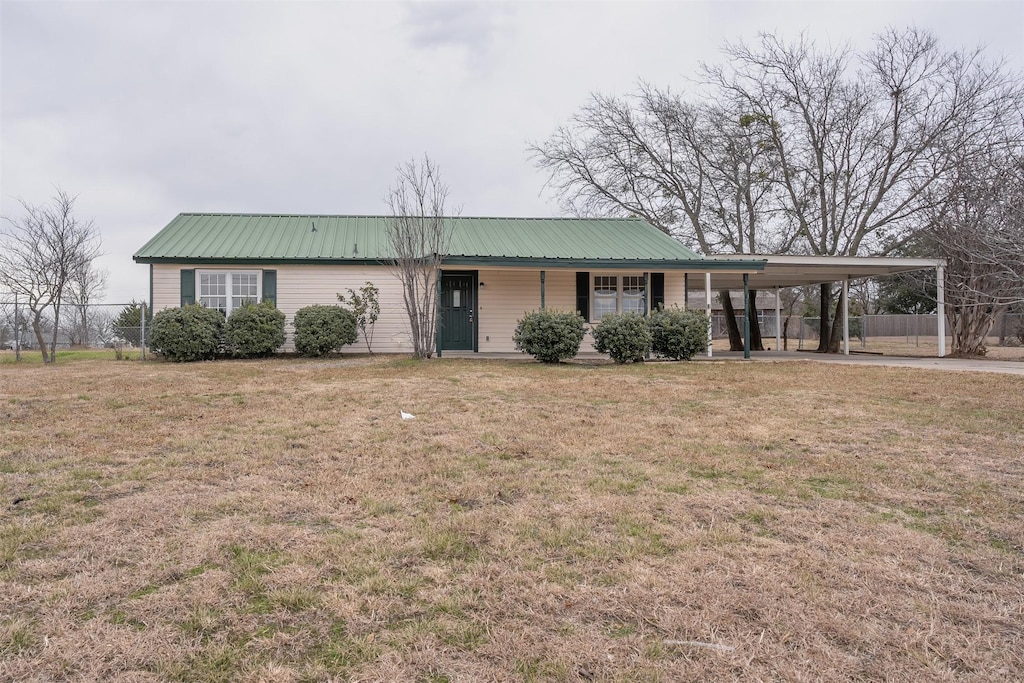 ranch-style house with a front lawn and a carport