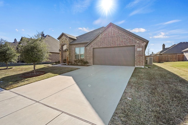 view of front facade with driveway, a garage, brick siding, fence, and a front lawn