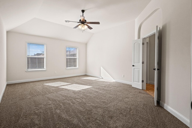 unfurnished room with ceiling fan, carpet, and vaulted ceiling