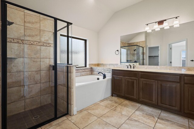 bathroom with lofted ceiling, tile patterned floors, separate shower and tub, and vanity