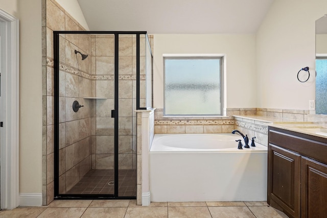 bathroom with lofted ceiling, vanity, separate shower and tub, and tile patterned floors