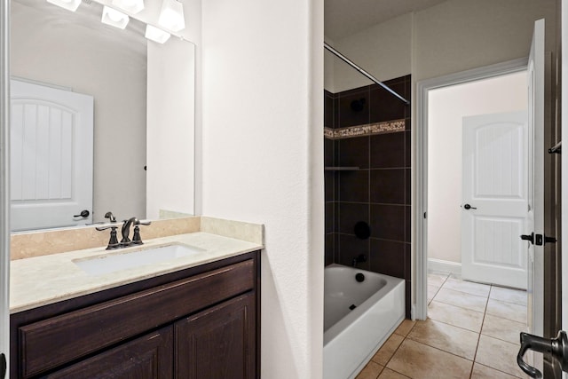 bathroom featuring tiled shower / bath combo, tile patterned floors, and vanity