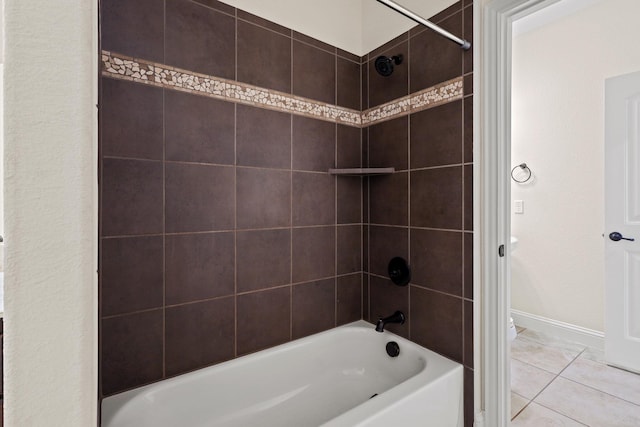 bathroom with tiled shower / bath combo and tile patterned flooring