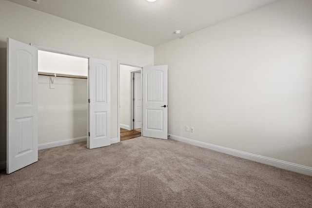 unfurnished bedroom with a closet and carpet floors