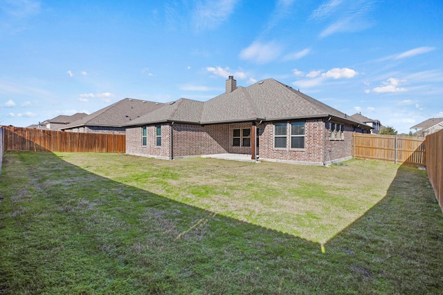 back of property with a patio area and a lawn