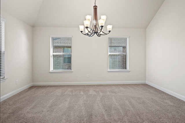 carpeted spare room with vaulted ceiling and a notable chandelier