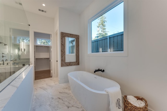 bathroom with sink and independent shower and bath