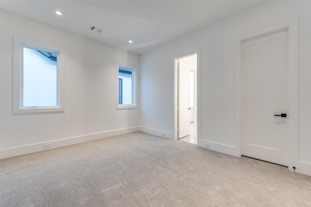 unfurnished bedroom featuring light carpet