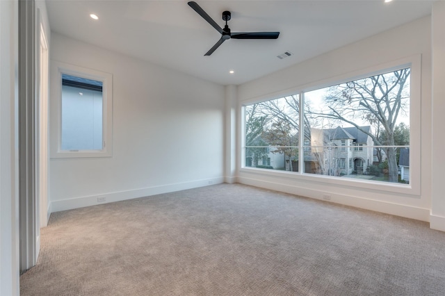 empty room with light carpet and ceiling fan