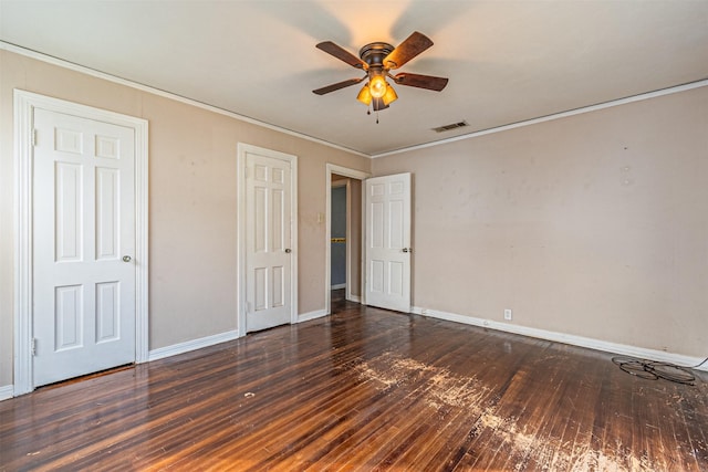 unfurnished bedroom with dark wood-type flooring, ceiling fan, and ornamental molding