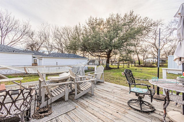 wooden terrace featuring a lawn