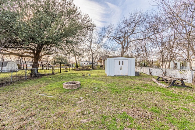 view of yard featuring an outdoor fire pit and a shed