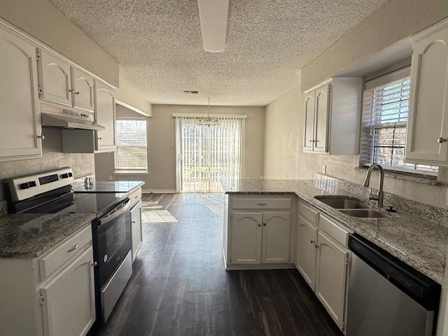 full bathroom featuring toilet, vanity, hardwood / wood-style floors, a textured ceiling, and bathing tub / shower combination