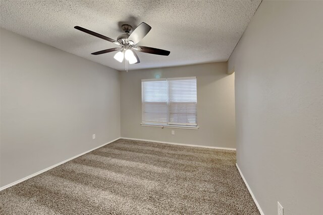 carpeted empty room with ceiling fan and a textured ceiling