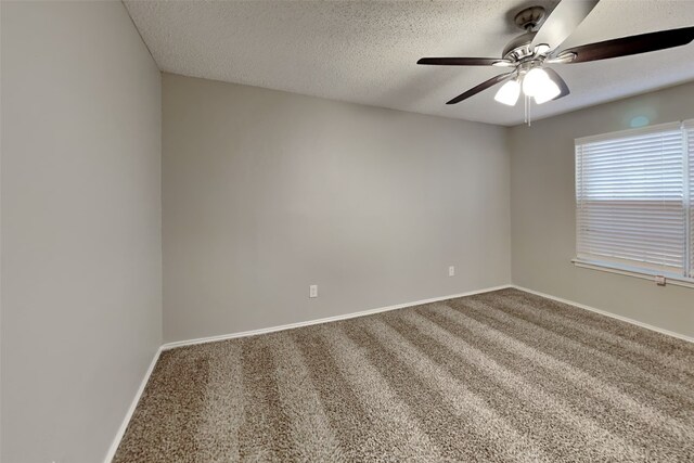 unfurnished room featuring a textured ceiling, ceiling fan, and carpet flooring