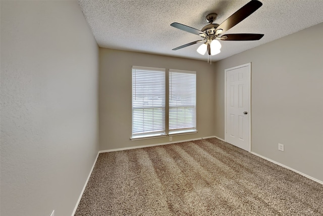 carpeted spare room featuring a textured ceiling and ceiling fan