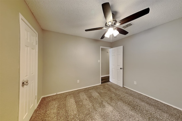 unfurnished bedroom with ceiling fan, carpet, and a textured ceiling