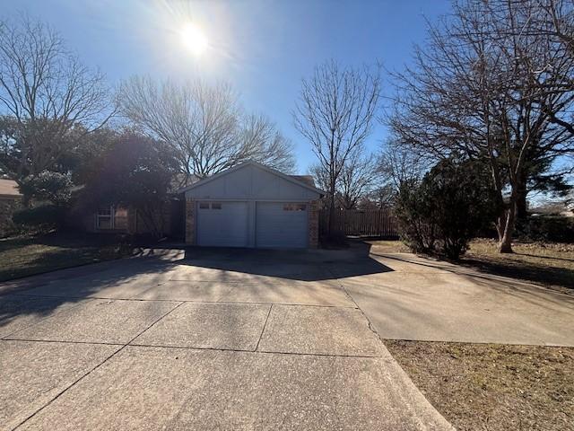 view of side of home featuring a garage and an outdoor structure