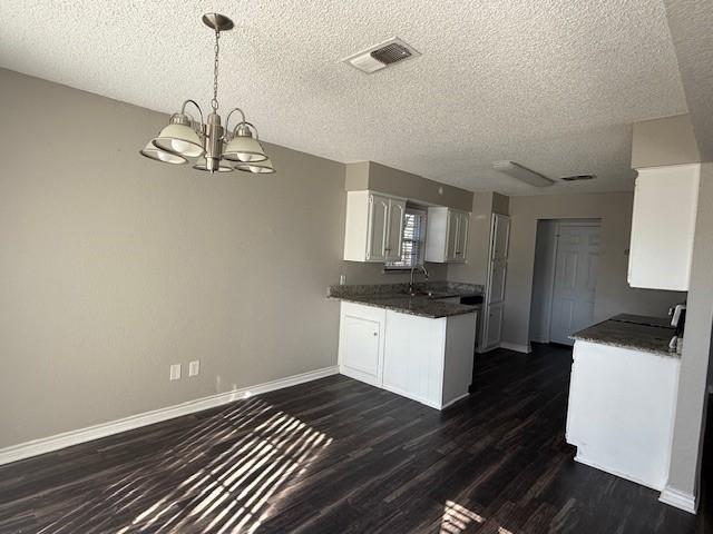 spare room with a textured ceiling, ceiling fan, and carpet