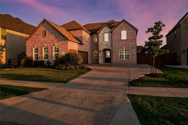 view of front of home featuring a garage and a lawn