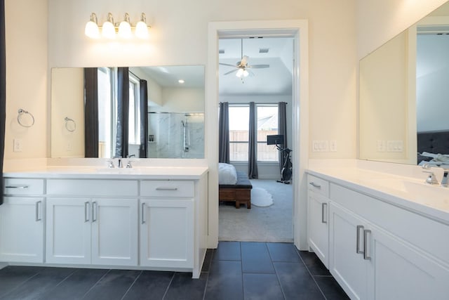 bathroom with walk in shower, ceiling fan, vanity, and tile patterned flooring