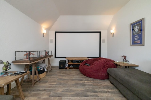 cinema room featuring lofted ceiling and hardwood / wood-style floors