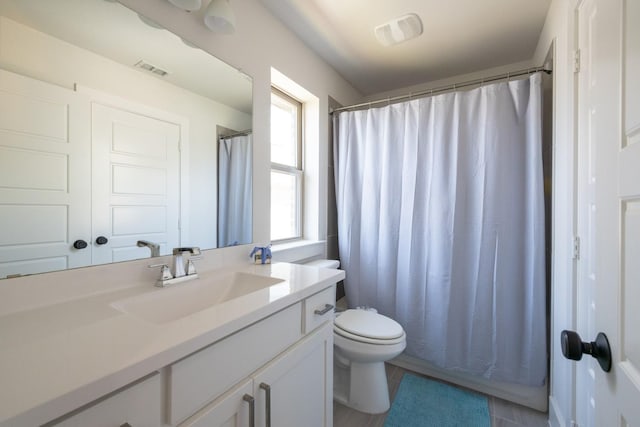 bathroom with vanity, toilet, and curtained shower