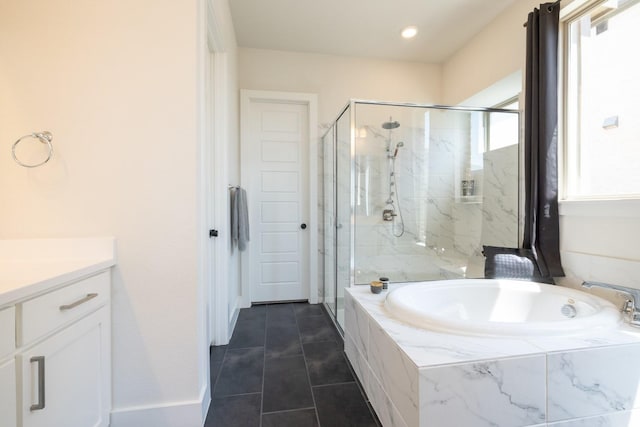 bathroom with tile patterned floors, vanity, and separate shower and tub