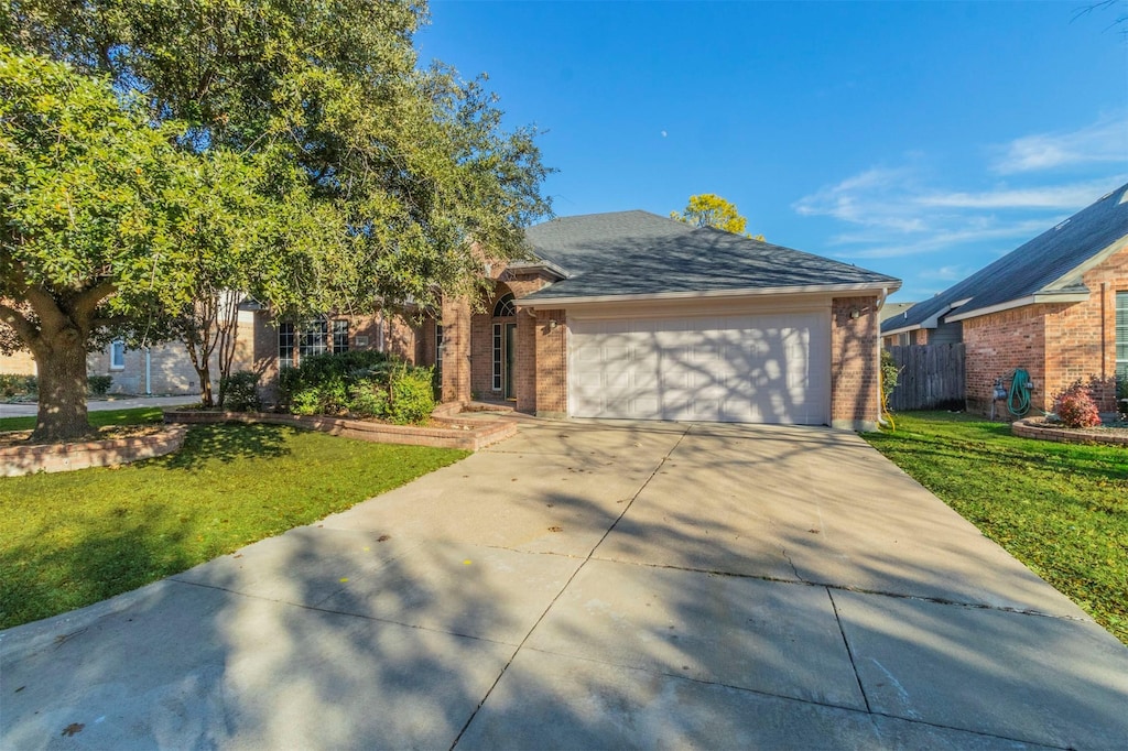 view of front facade with a front yard and a garage