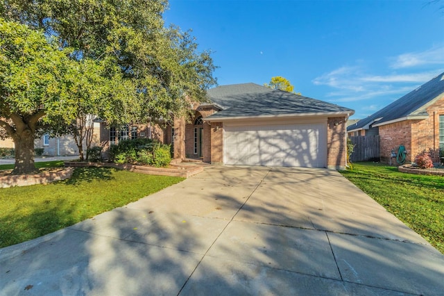 view of front facade with a front yard and a garage