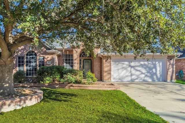 view of front of property featuring a front lawn and a garage