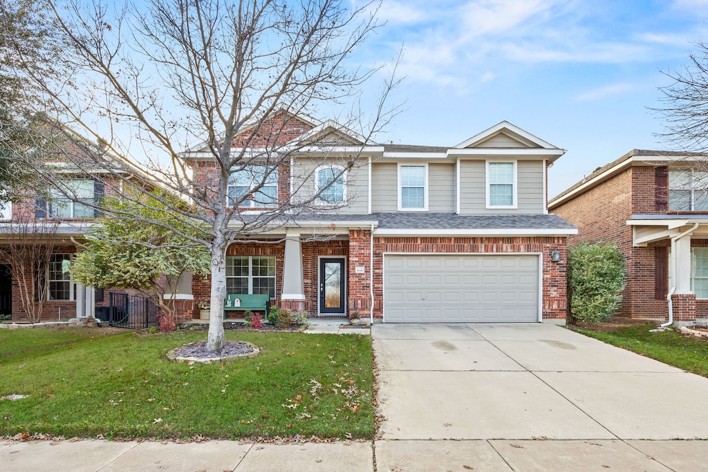 view of front of home with a garage and a front lawn