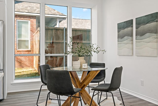 dining area featuring a wealth of natural light and hardwood / wood-style floors