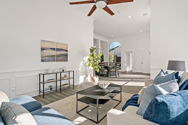 living room featuring ceiling fan and light hardwood / wood-style floors