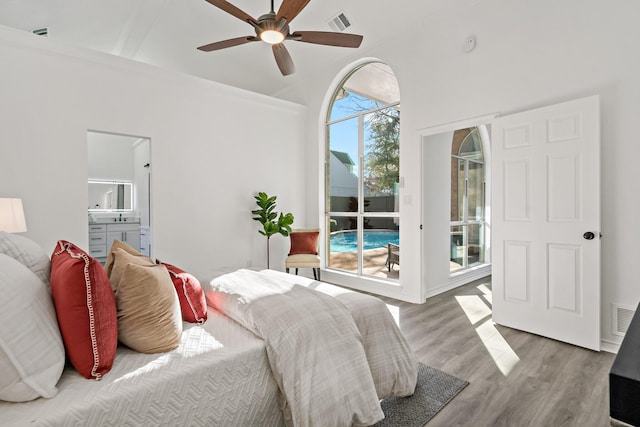 bedroom with ceiling fan, connected bathroom, hardwood / wood-style flooring, and access to outside