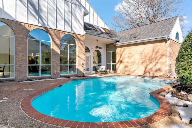 view of swimming pool featuring ceiling fan and a patio area