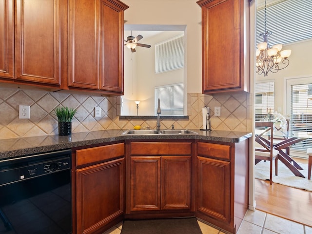 kitchen featuring light tile patterned floors, decorative backsplash, dishwasher, ceiling fan with notable chandelier, and sink