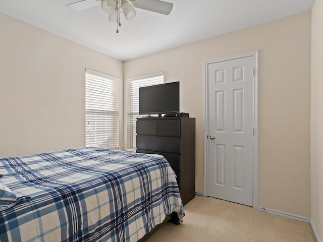 bedroom featuring ceiling fan and light carpet