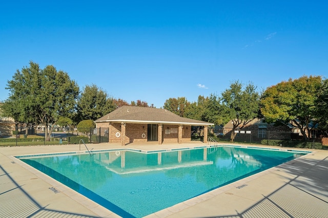 view of swimming pool with a patio