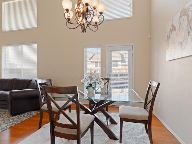 dining area featuring hardwood / wood-style flooring and a notable chandelier