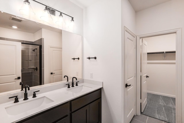 bathroom featuring an enclosed shower, vanity, and tile patterned flooring