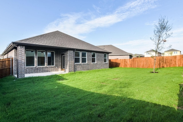 back of house featuring a yard