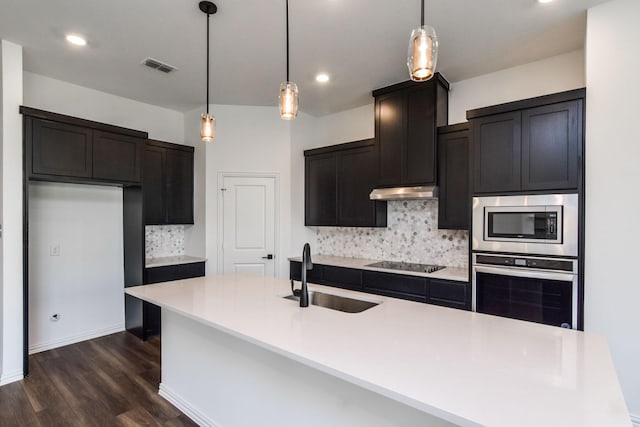 kitchen featuring decorative backsplash, sink, stainless steel appliances, and pendant lighting