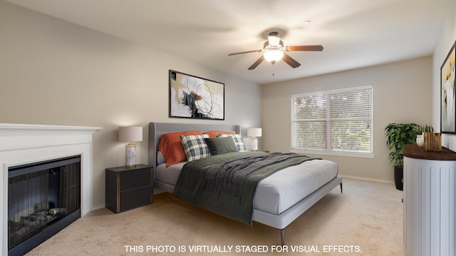 bedroom featuring ceiling fan and light carpet