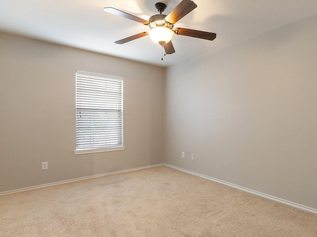 spare room featuring ceiling fan and light colored carpet