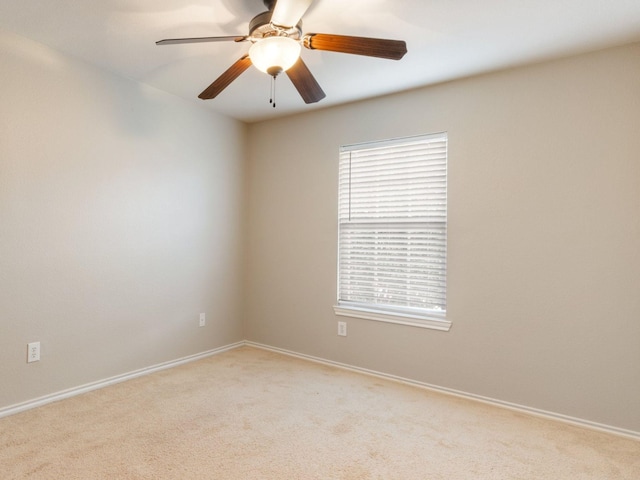 spare room with light carpet and ceiling fan