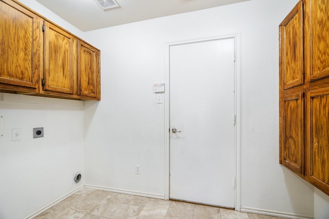 clothes washing area with cabinets and hookup for an electric dryer