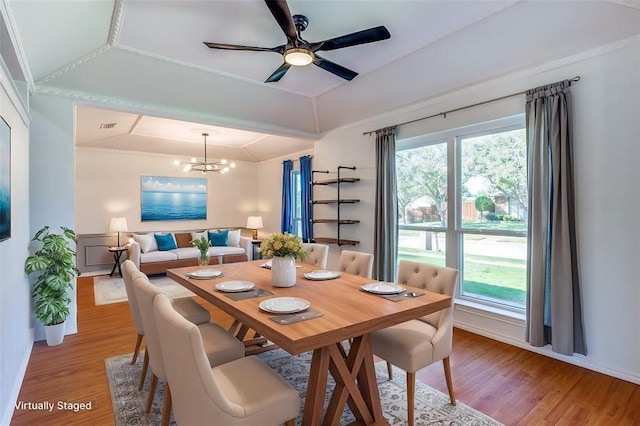 dining area with ceiling fan with notable chandelier, visible vents, light wood-style flooring, and baseboards