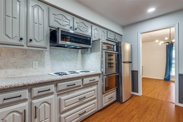 kitchen featuring lofted ceiling with beams, dishwasher, sink, and gray cabinetry